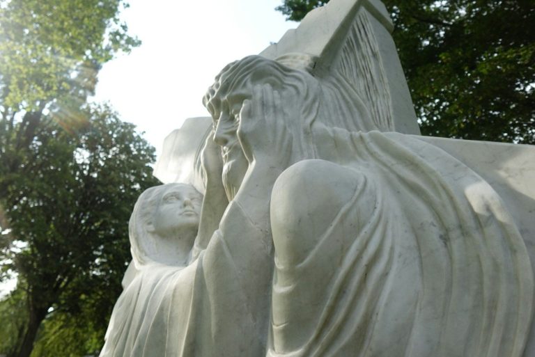 a close up of a statue of a person holding a child