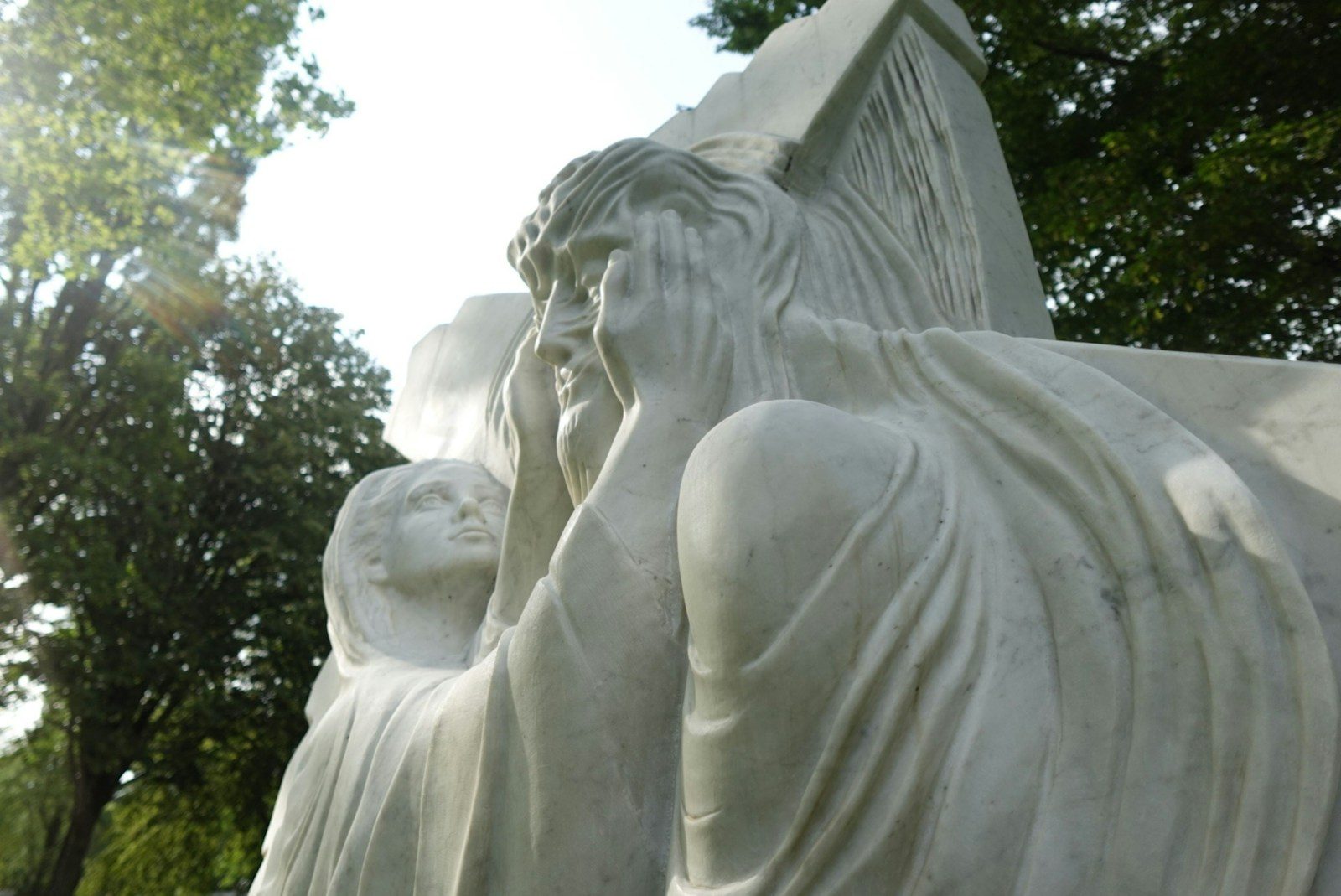 a close up of a statue of a person holding a child